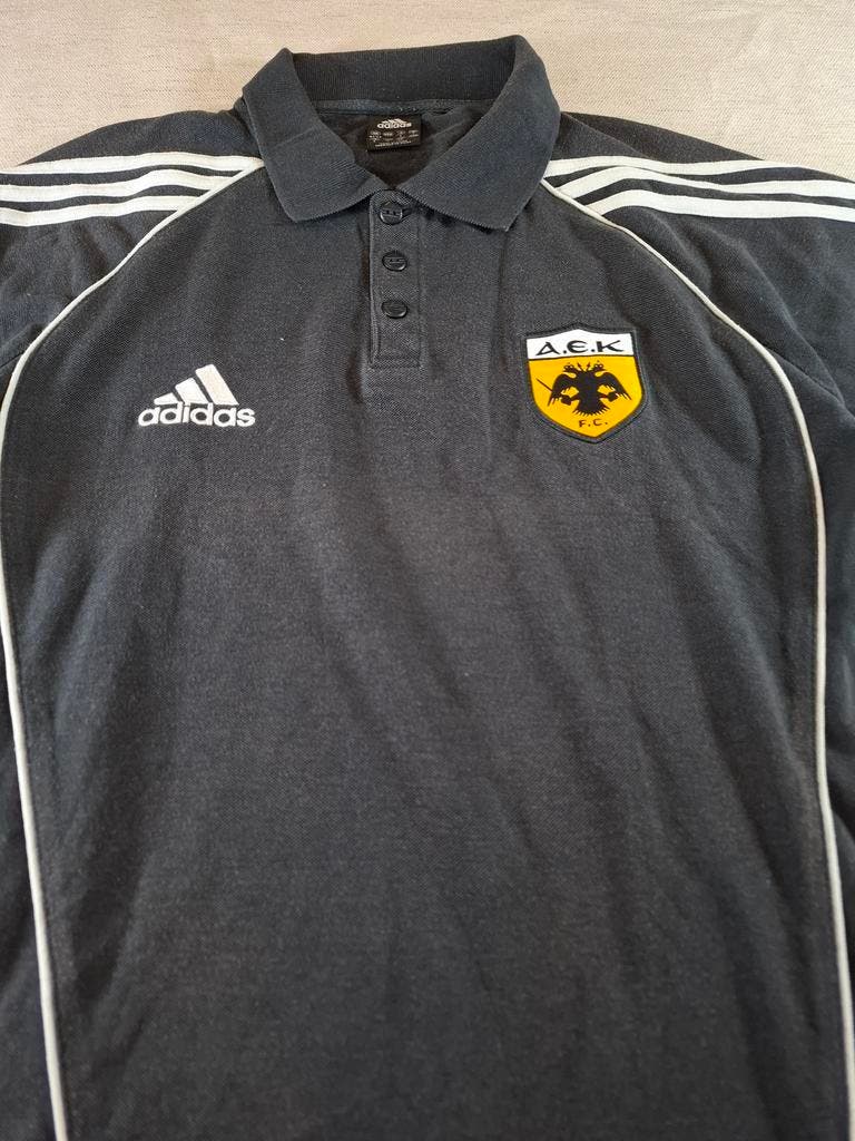 000127 – Adidas AEK Athens Polo – Black, Size L (UK 42/44)